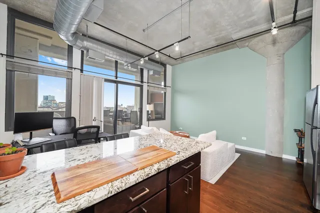 a view of a workspace with furniture and a window