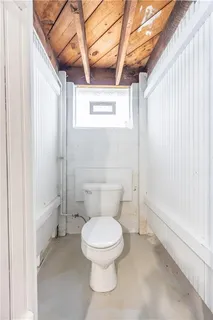 a white toilet sitting next to a bathroom sink