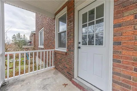 a view of a balcony with a floor to ceiling window and wooden floor