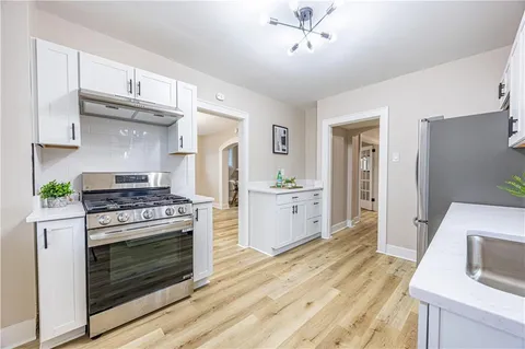 a kitchen with a stove oven and sink