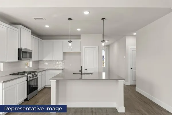 a large kitchen with stainless steel appliances kitchen island a stove a sink a refrigerator a center island a stove and a window