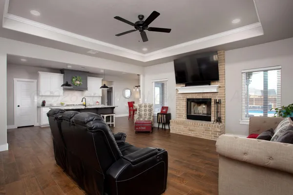 a living room with furniture a fireplace and a flat screen tv