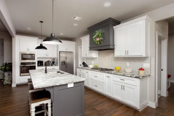 a kitchen with cabinets and wooden floor