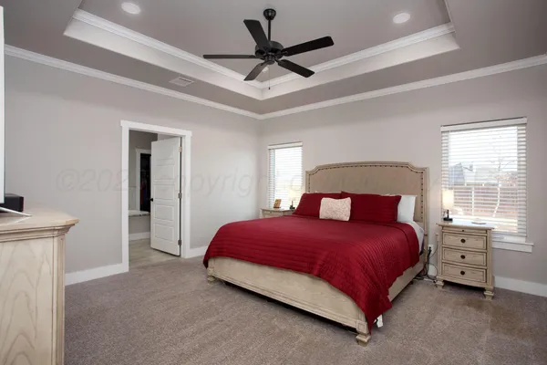 a bedroom with a bed and a ceiling fan