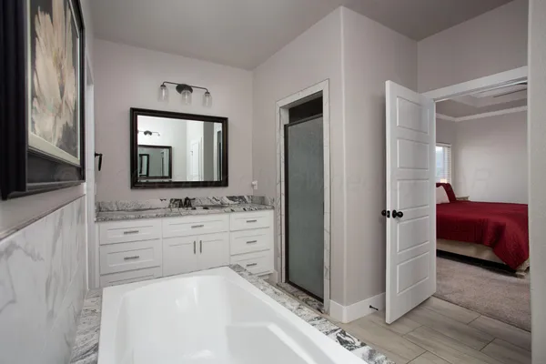 a en suite bathroom with a double vanity sink and a mirror