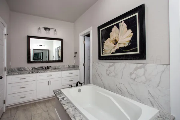 a bathroom with a bathtub and a sink