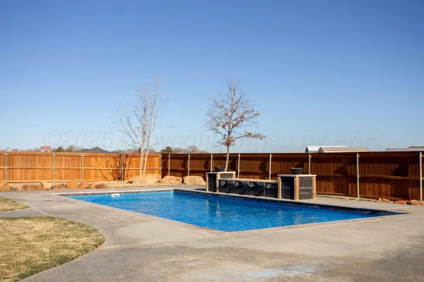 a view of a swimming pool with an outdoor seating