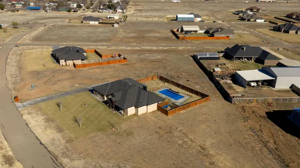 an aerial view of a house with outdoor space
