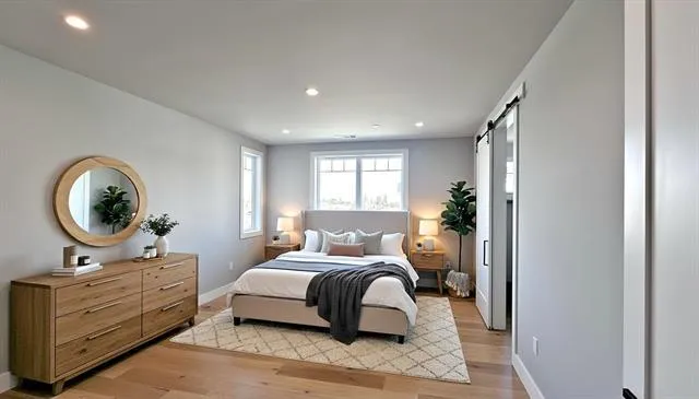 a bedroom with a large bed and a mirror