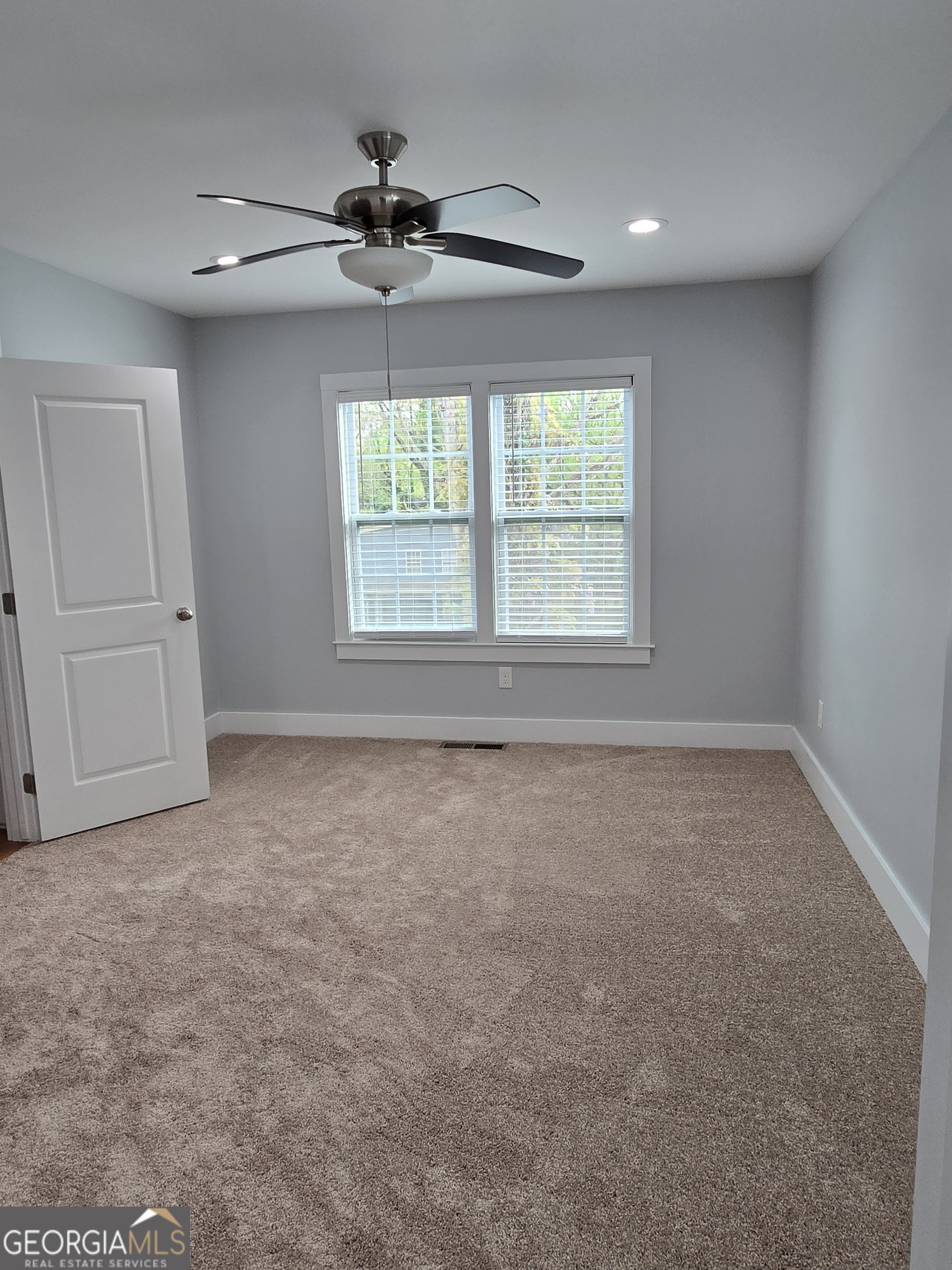 4075 Fairburn Avenue Southwest Atlanta, GA 30331 - Photo 7 of 12 an empty room with a window and a fan
