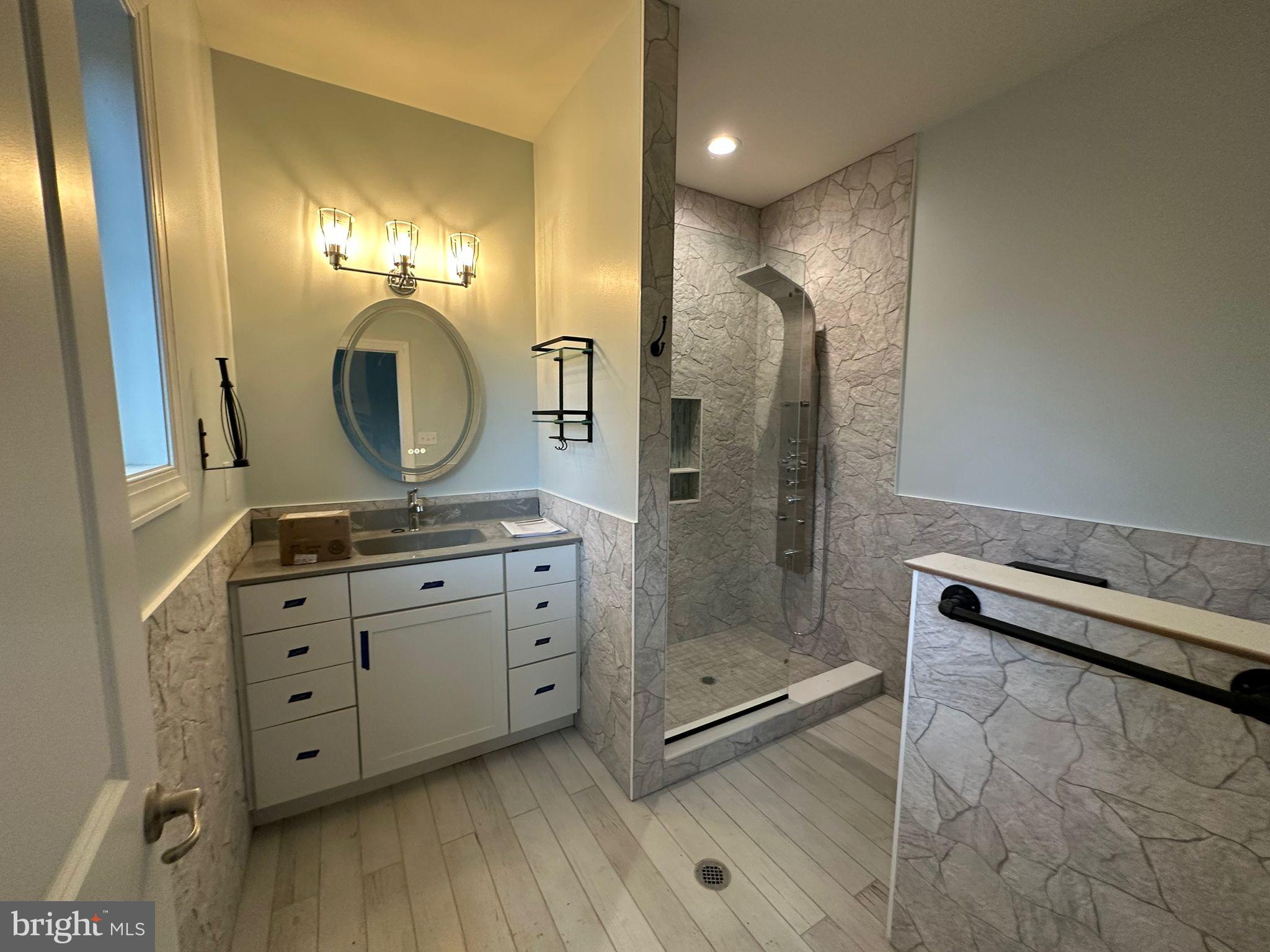 64 B Kirk Road Garnet Valley, PA 19060 - Photo 16 of 37 a bathroom with a granite countertop sink a mirror and shower
