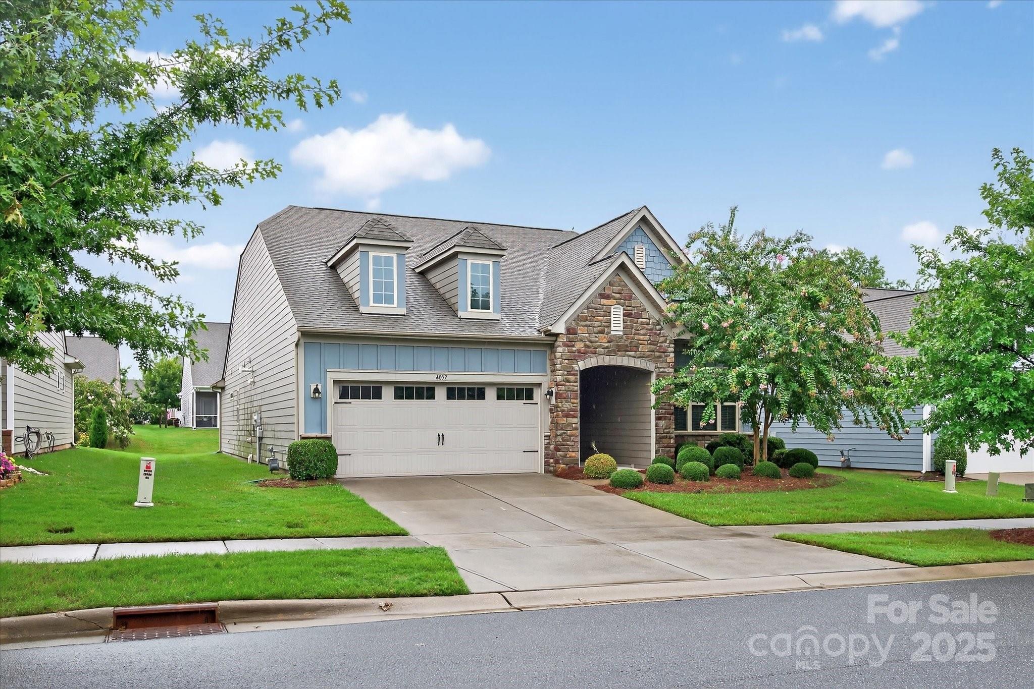 4057 Channel Islands Way Lancaster, SC 29720 - Photo 1 of 34 a front view of a house with a garden and plants