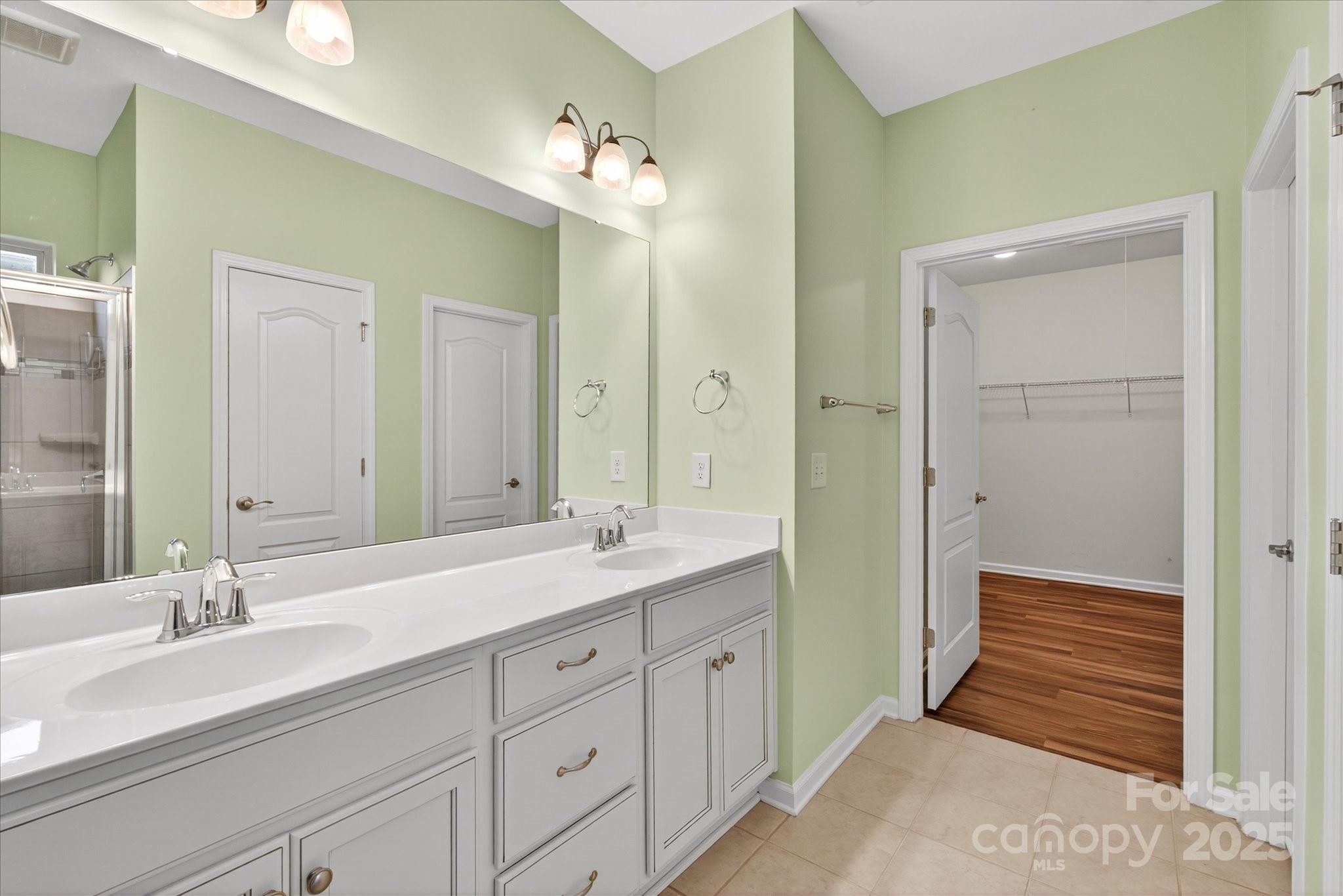 4057 Channel Islands Way Lancaster, SC 29720 - Photo 14 of 34 a en suite bathroom with double sink and a large mirror