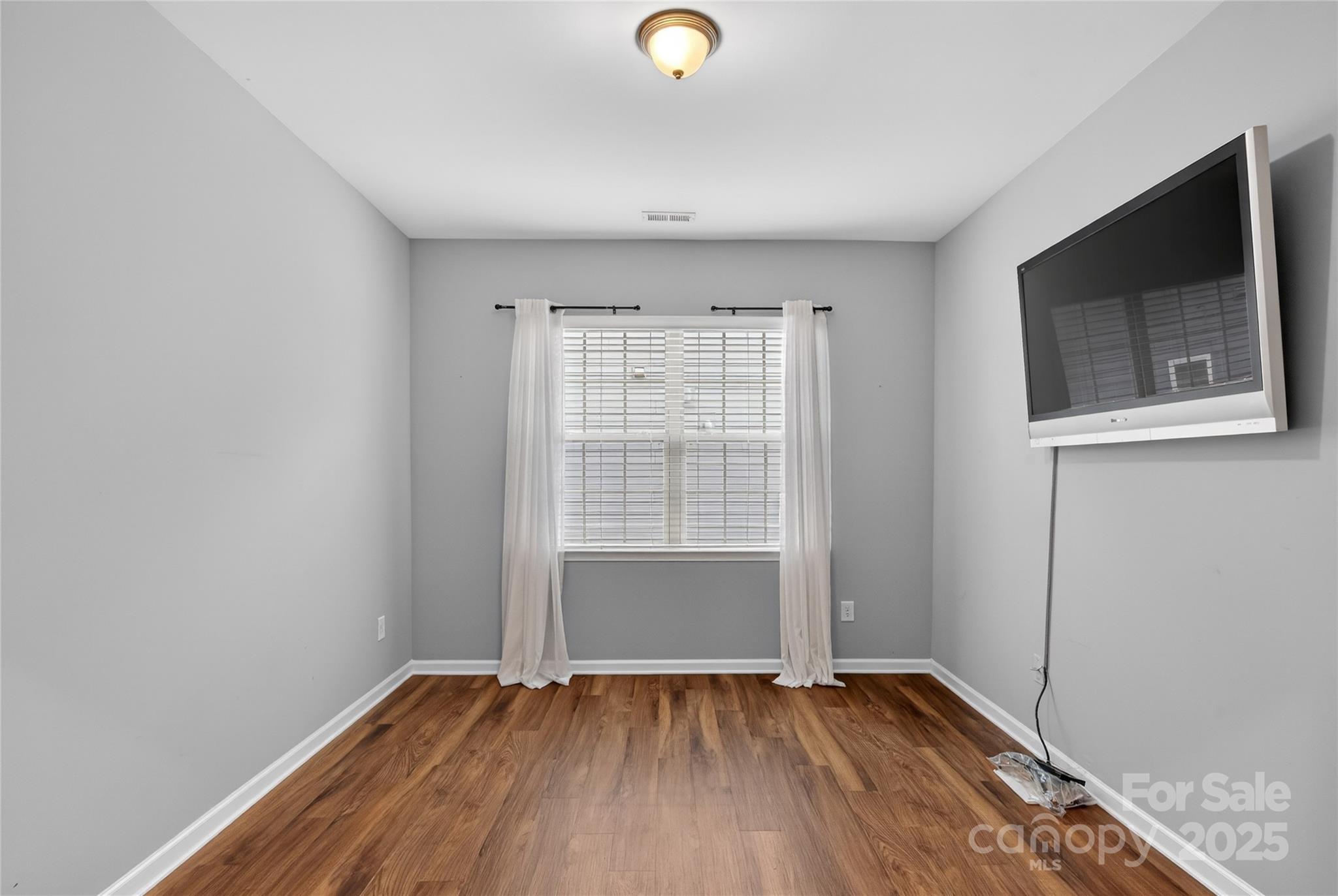 4057 Channel Islands Way Lancaster, SC 29720 - Photo 16 of 34 a view of an empty room with wooden floor and a window