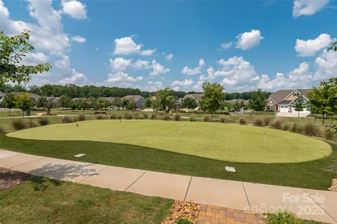 an aerial view of a house with garden space and street view