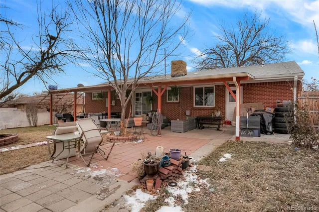 a view of a house with backyard porch and sitting area