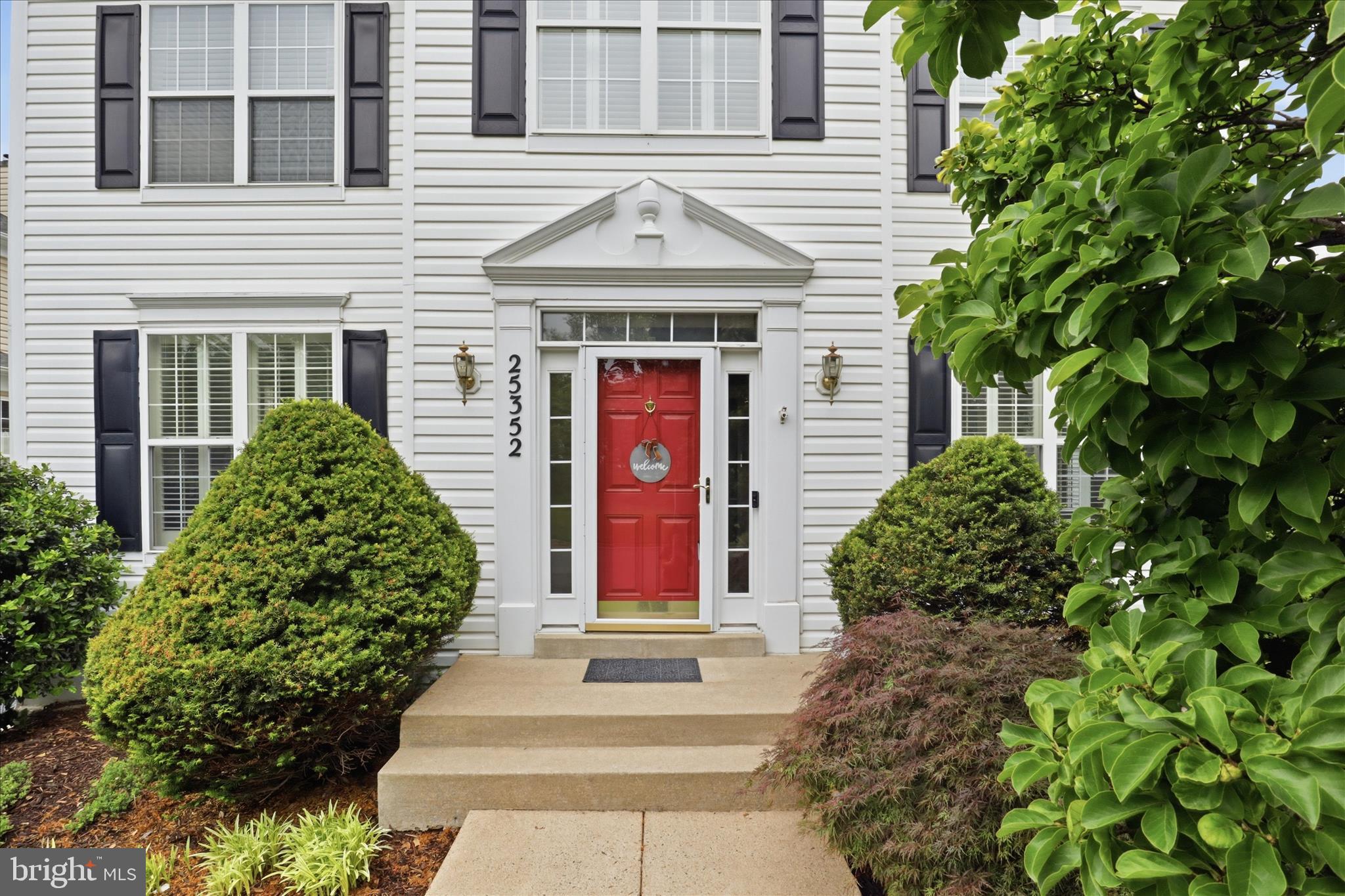 25352 Ripleys Field Drive Chantilly, VA 20152 - Photo 34 of 54 a front view of a house with plants and entryway
