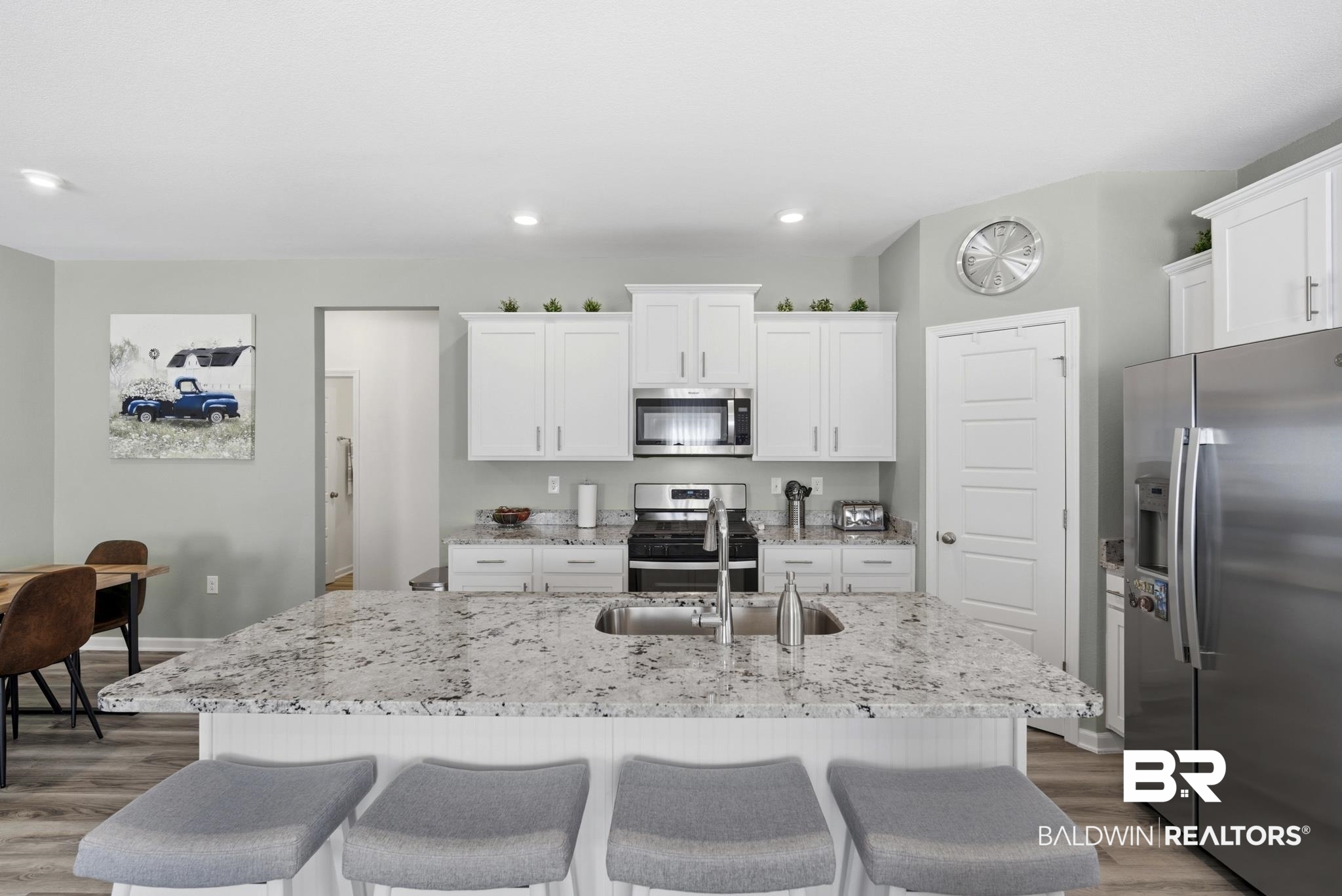 13887 Antler Hl Road Daphne, AL 36527 - Photo 10 of 50 Kitchen with stainless steel appliances, light wood-style floors, an island with sink, white cabinetry, and recessed lighting