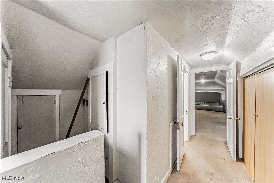 2014 Cook Avenue Cleveland, OH 44109 - Photo 20 of 37 Hallway with vaulted ceiling and a textured ceiling