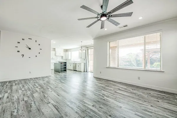 a kitchen with granite countertop a sink a window stainless steel appliances and cabinets