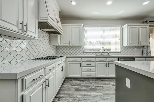 a kitchen with stainless steel appliances a stove top oven and sink