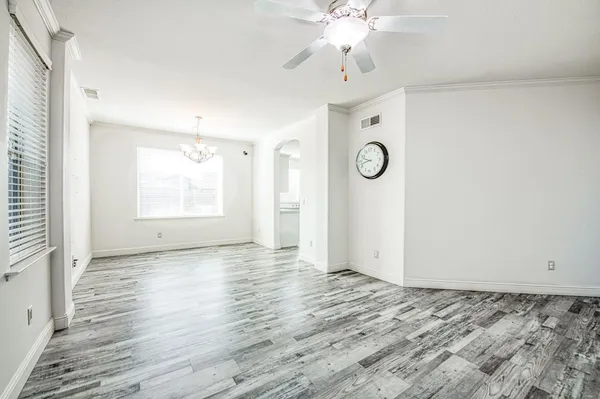 a view of empty room with wooden floor fireplace and windows