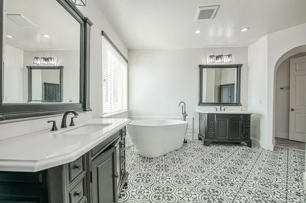 a bathroom with a tub sink and mirror