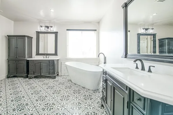 a bathroom with a granite countertop sink a toilet and shower