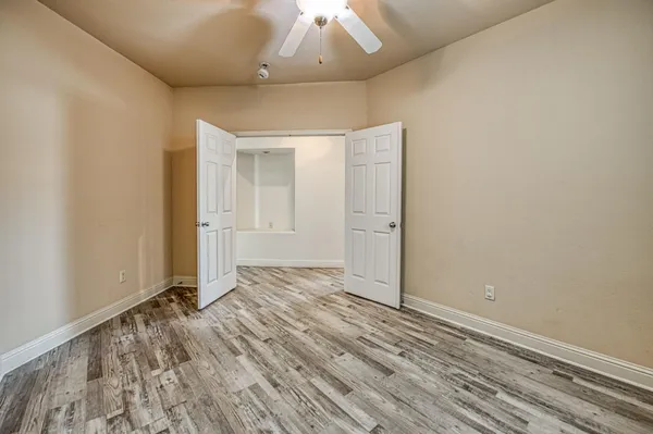 an empty room with windows and closet
