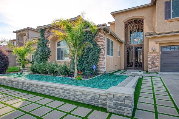 a front view of a house with garden