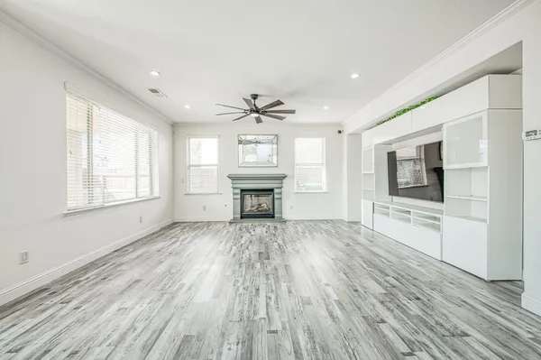 a living room with a flat screen tv a rug and a fireplace