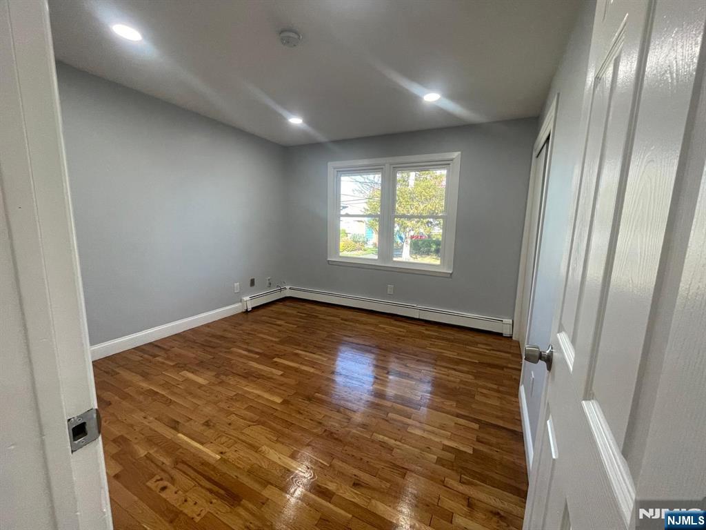85 Grove Street, Unit 1 South Hackensack, NJ 07606 - Photo 8 of 9 a view of empty room with wooden floor