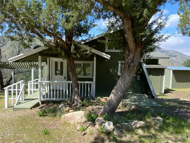 a view of a house with backyard porch and sitting area