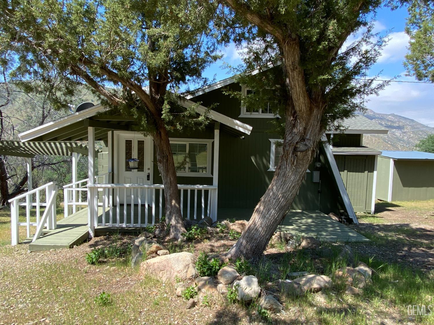 a view of a house with backyard porch and sitting area