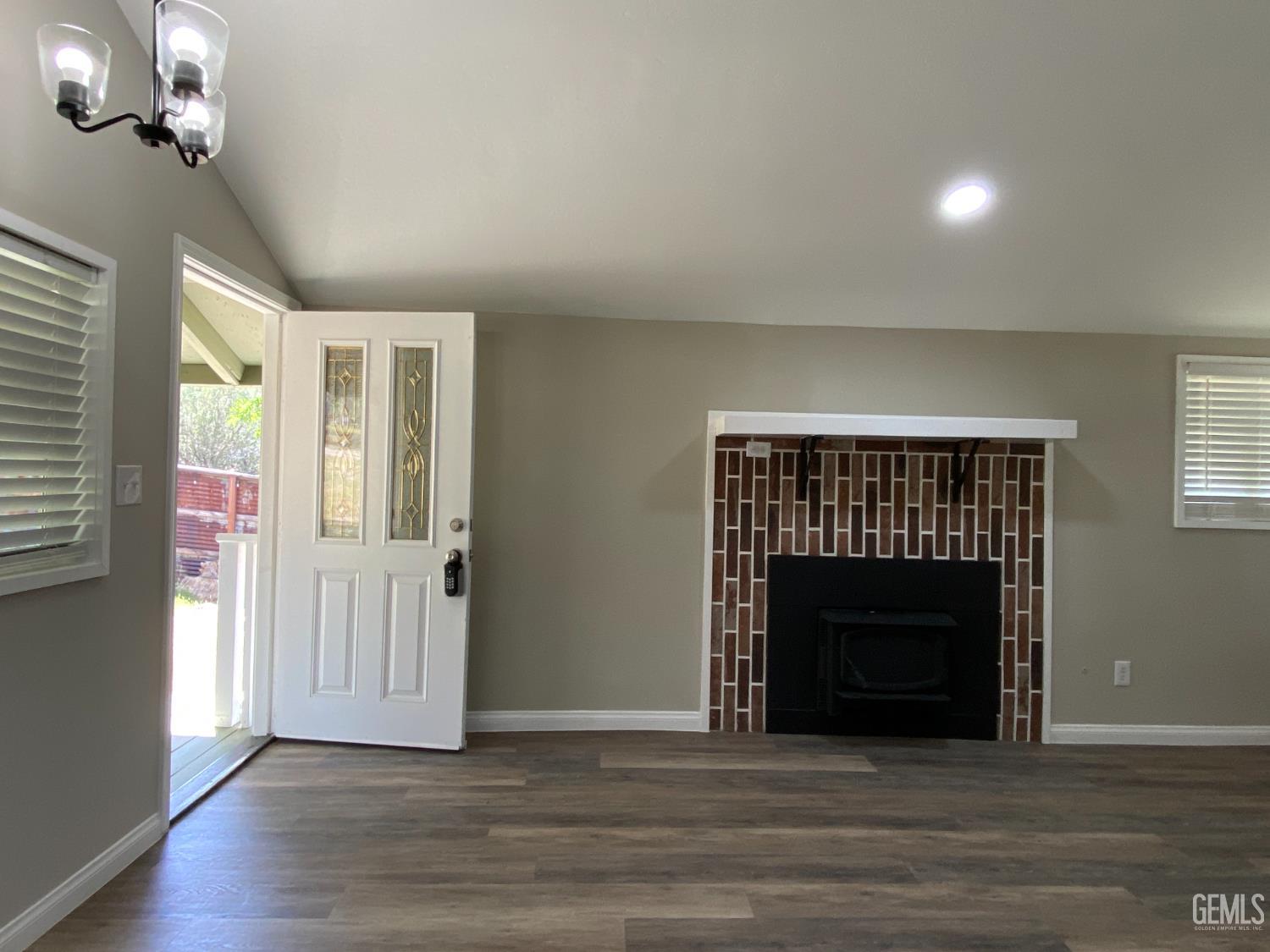 Undisclosed Address Caliente, CA 93518 - Photo 18 of 33 a view of an empty room with wooden floor fireplace and a window