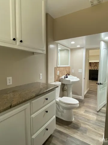 a bathroom with a toilet sink and mirror