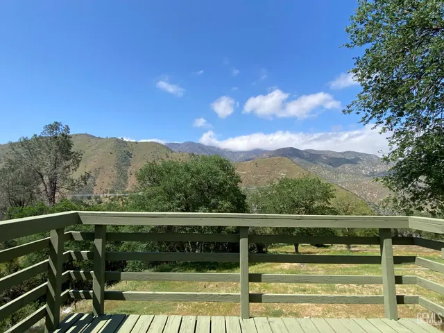 a view of balcony with wooden floor and fence