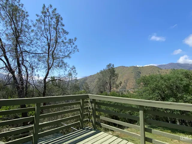 a view of balcony with wooden floor and fence
