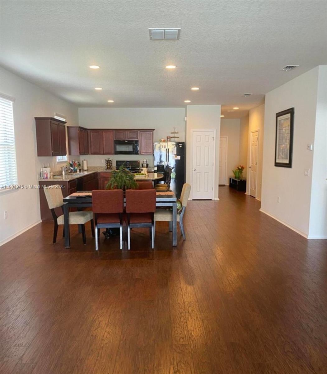 15718 Stone House Drive Spring Hill, FL 34604 - Photo 3 of 10 a view of a dining room with furniture and window