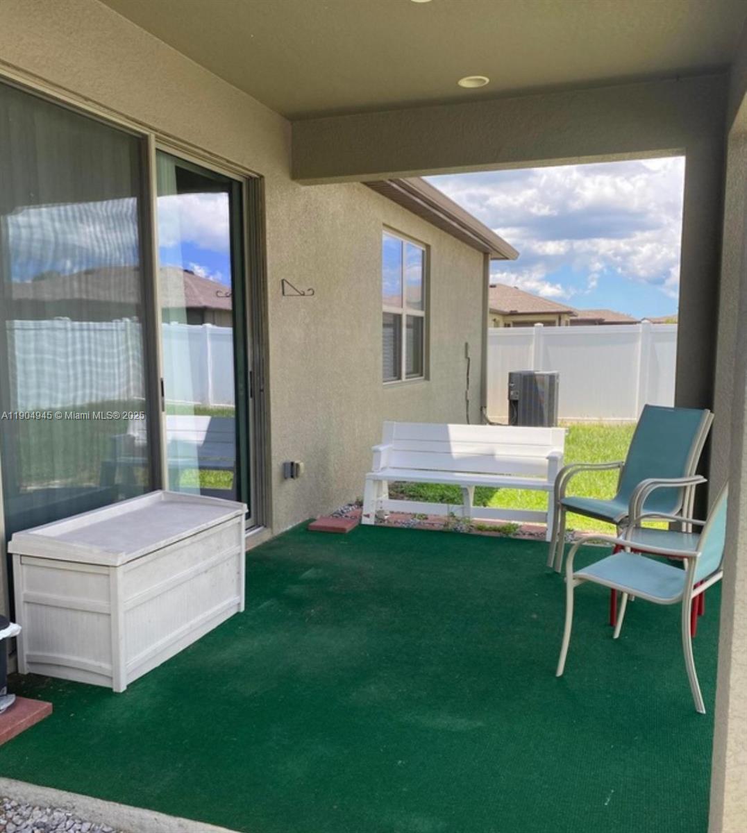 15718 Stone House Drive Spring Hill, FL 34604 - Photo 5 of 10 a backyard of a house with table and chairs