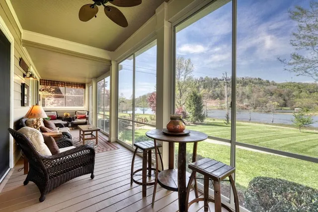 a view of a room with a large window and wooden floor