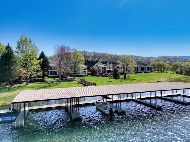 a view of a brick house with large windows and plants