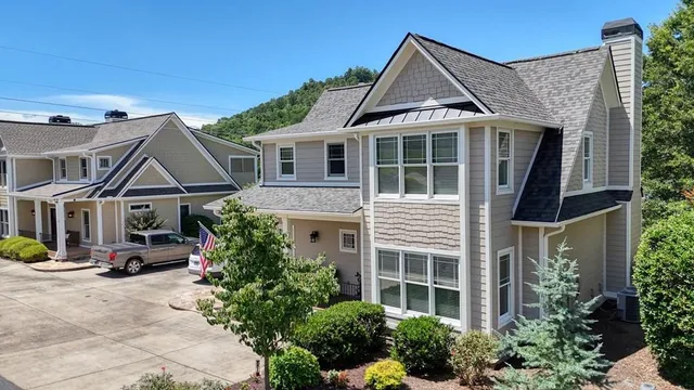 a front view of a house with a garden