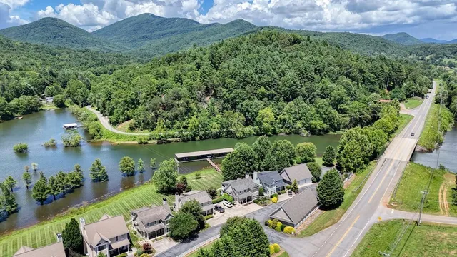 an aerial view of a house with a yard and lake view