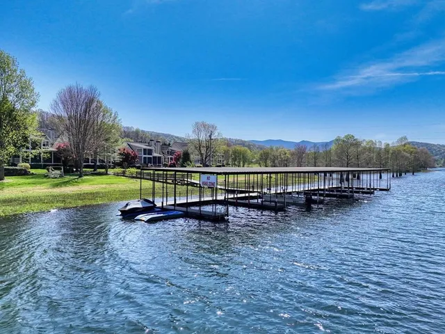 a view of house with deck and wooden floor