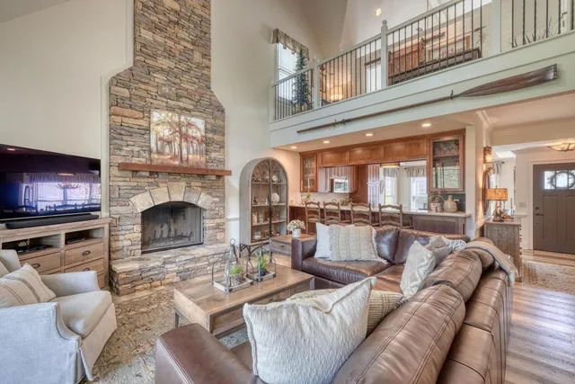a living room with furniture a fireplace and a flat screen tv