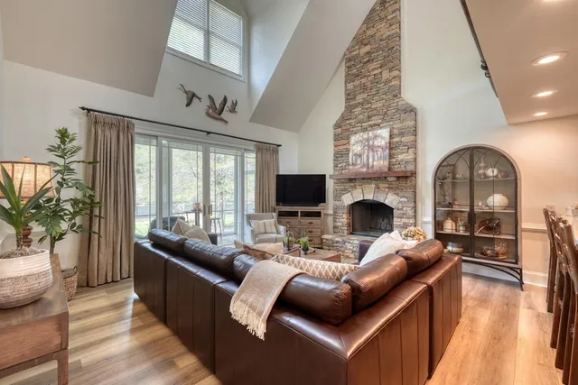 a living room with furniture a fireplace and a flat screen tv