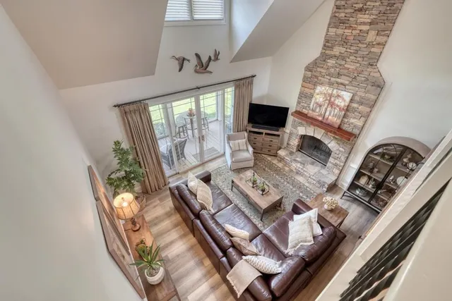 a view of living room with furniture and a fireplace