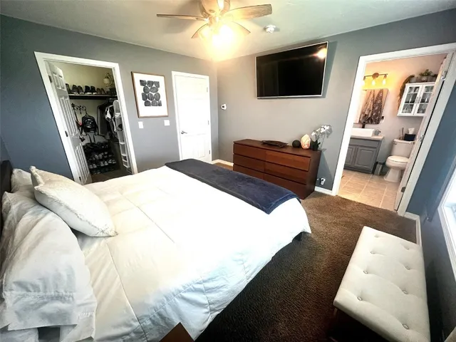 a living room with a bed furniture and a flat screen tv