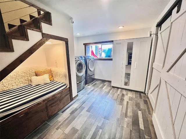 a view of a hallway with wooden floors and stairs
